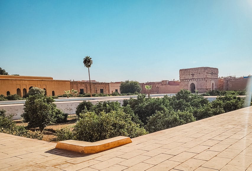 A massive courtyard is visible, with the ruins of the surroudning palace around it, and some greenery in a basin in the middle. This is the El Badii Palace in Marrakech.