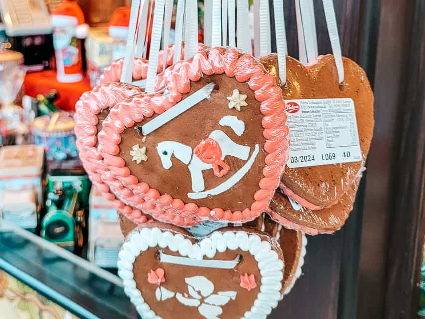 Gingerbread shaped into hearts and decorated with icing, made to be ornaments.