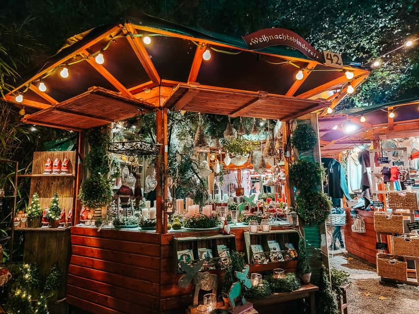 A cute, wooden stall selling greenery, set among the park at the Stadtgarden market.