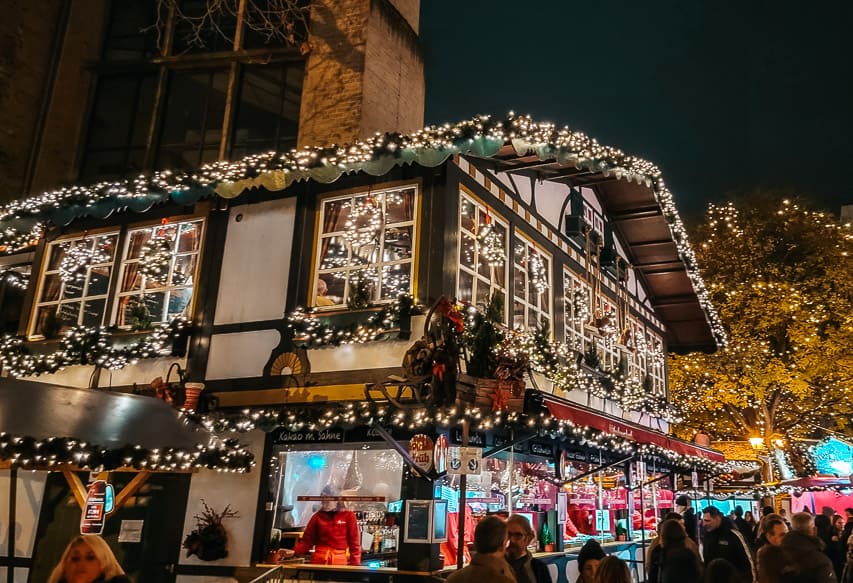 A Bavarian style house with timbers is light up in St. Nicolas Market in Cologne.