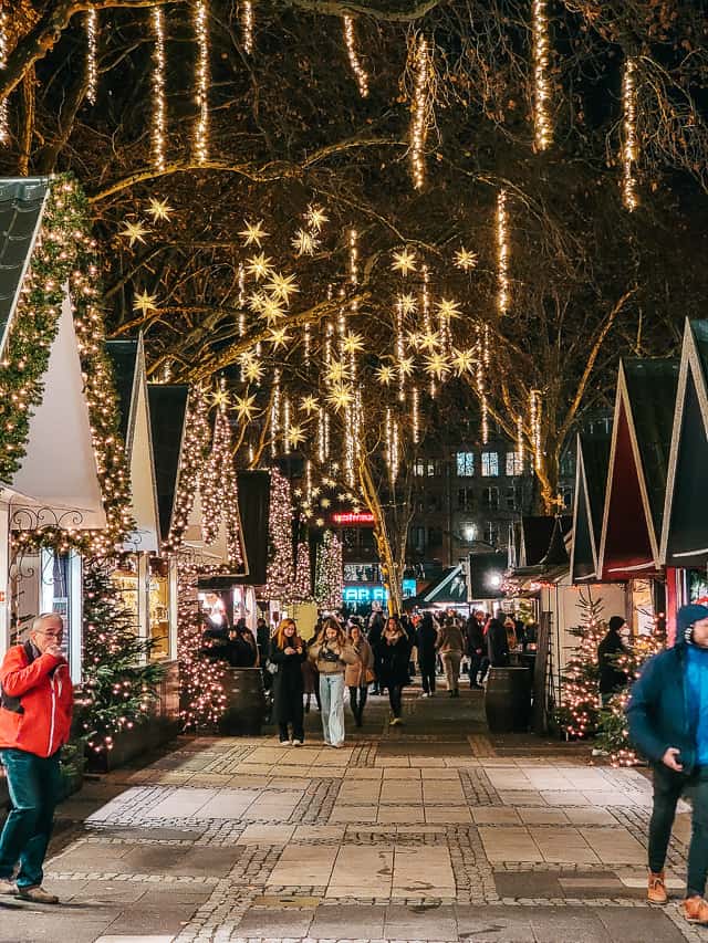 A pathway through the Angel Market that has stars and dangling lights in the trees.