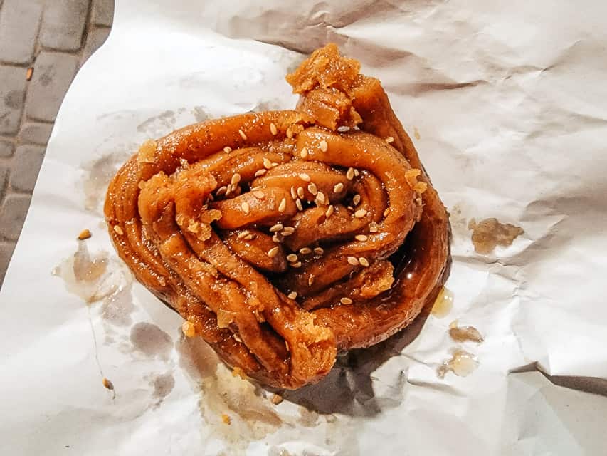 Chebakia, a spiraled, thin strip of dough twisted into the shape of a flour that has been fried and sprinkled with sesame seeds and honey.