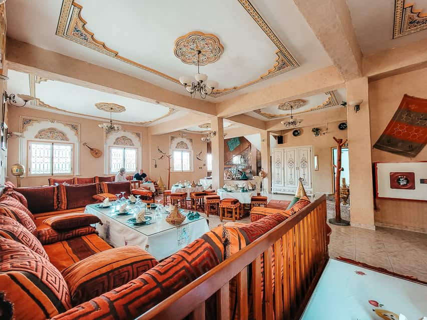 An elegant Moroccan dining room at Chez Michelle. Plush couches and well set tables are accented with beautiful ceilings.