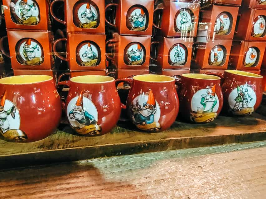 a close up of the red mugs with gnomes on them sold in Heinzel's Wintermarchen.