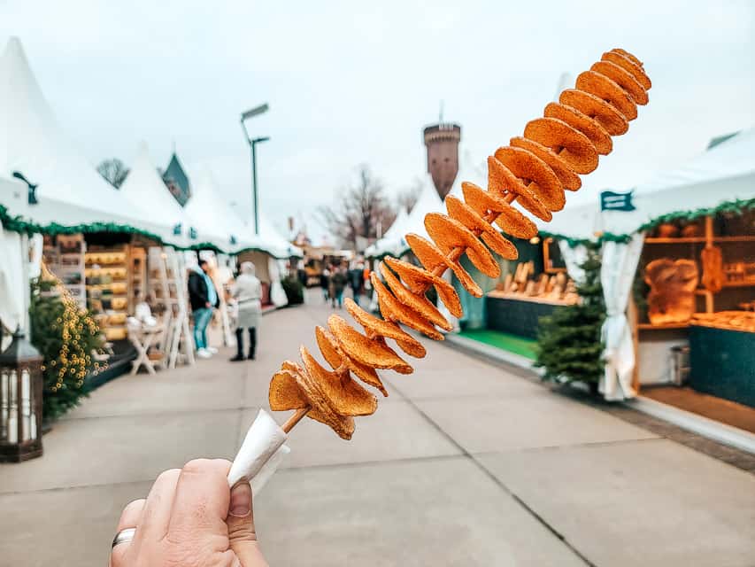 a spiraled slices potato on a stick that has been fried in the Harbor Market in Cologne.
