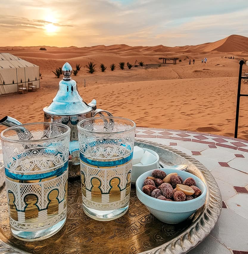 A Moroccan tea pot and cups on a little table in the middle of the Sahara.