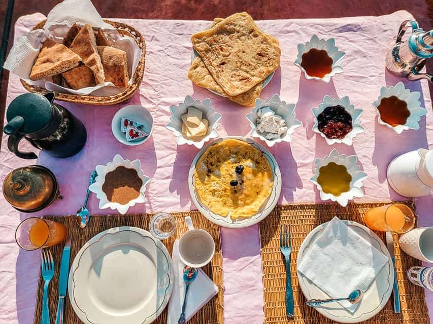 A breakfast offering in Morocco. Here eggs, bread, crepes and various toppings like jam, honey, soft cheeses and butter are offered.