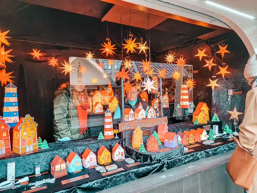 A stall in the Angel Market of Cologne selling paper houses and stars.