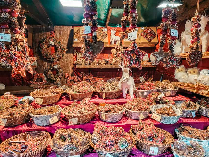 A closeup of a stall at the Cologne Christmas market selling baskets full of scented pine cones.