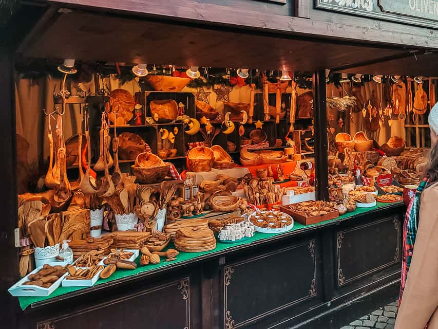 Wooden spoons, bowls, and other housewares in a market stall.