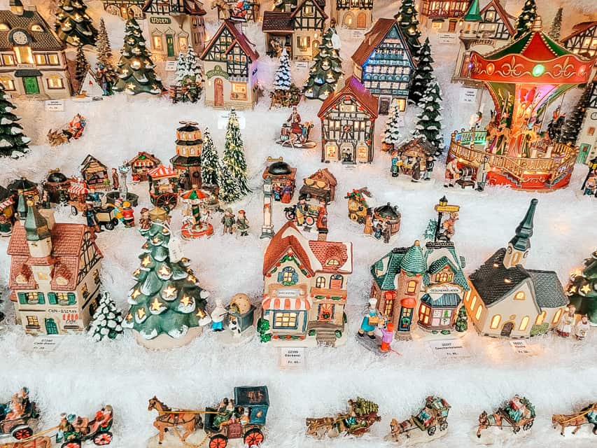 A stall with many little alpine ceramic houses and little village people.