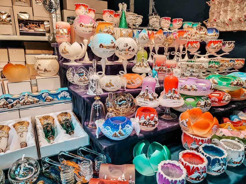 A booth selling a variety of handles and glass candle holders, usually in rounded containers.