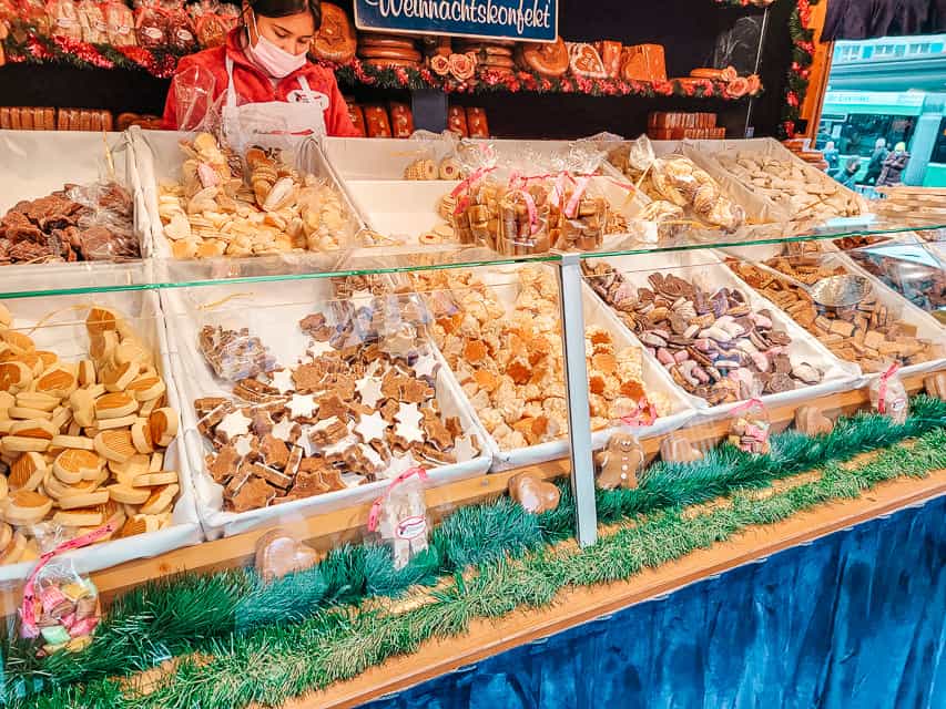 A dispaly case full of tubs of different small, regional cookies common in Switzerland, found at the Basel Christmas market.