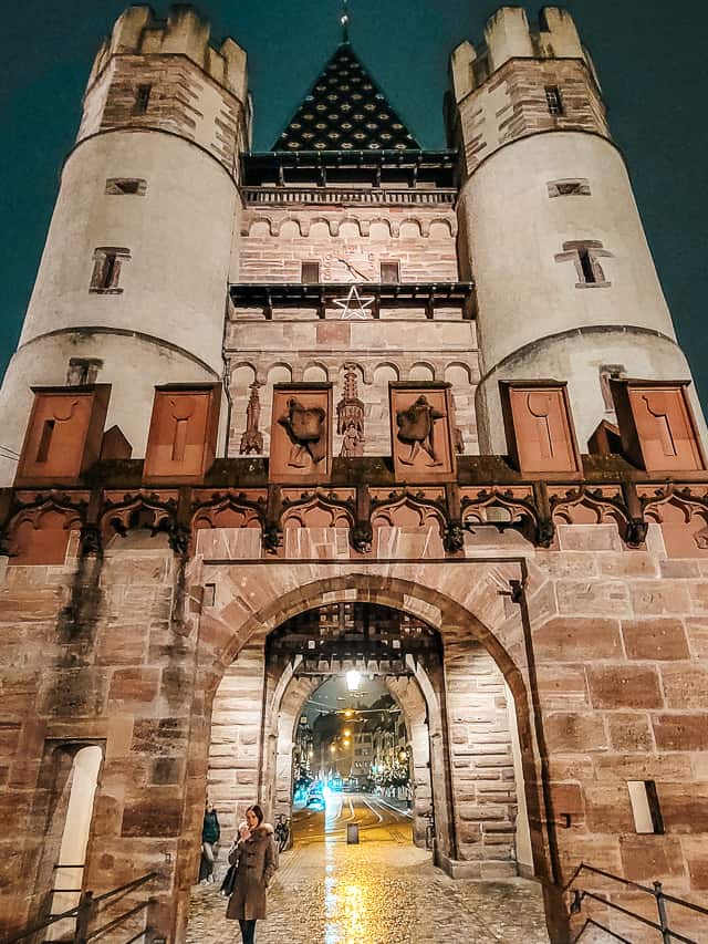 A square watchtower with turrets and an arched passageway through the bottom - the Gates of Spalen in Basel.