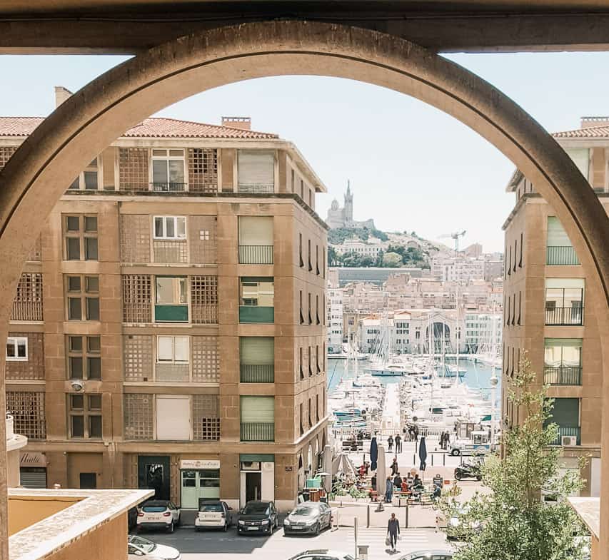 The view from a stone circular window looking out at the port with hundreds of boats.