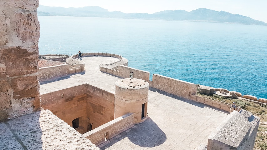 The top of the fortress looking out toward the gorgeous crystal blue water and the mountains in the background.