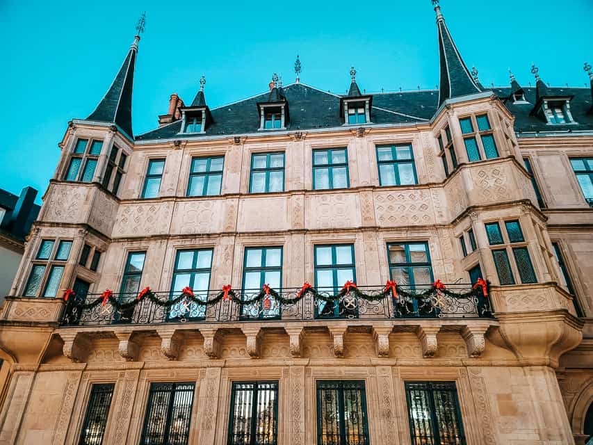 A view of the outside of the Grand Ducal Palace - a stone building with two turrets on either side.
