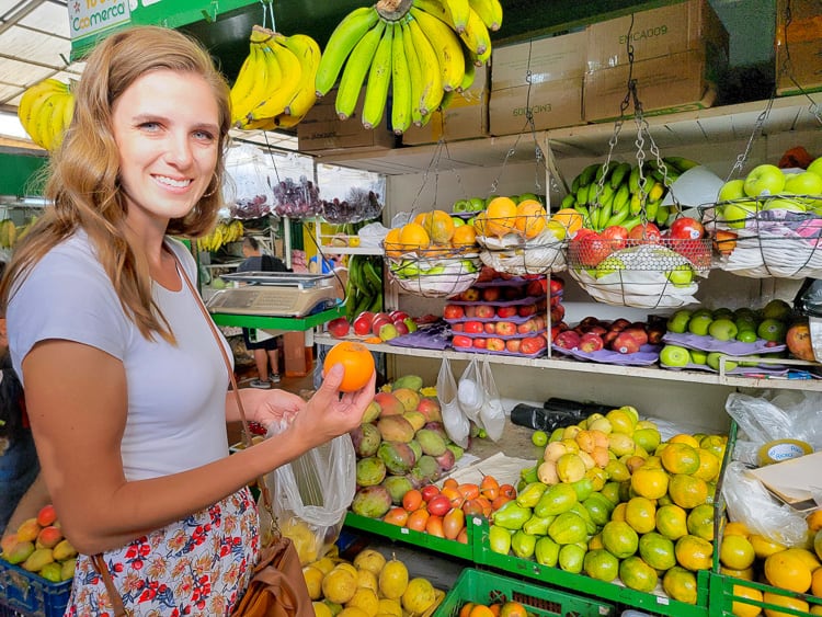 Woman shopping at fruit stall in Colombia.