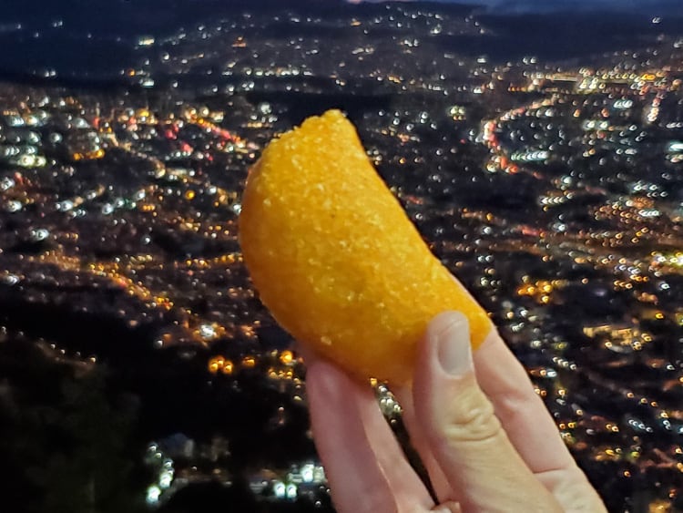 An empanada against a city nightscape.