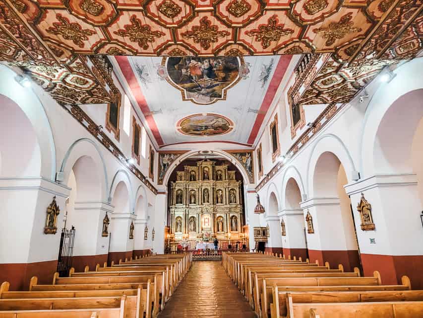 The inside of the Church of Candelaria, with a lot of murals on the ceilings.