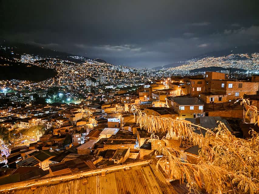The view of Medellin at night with the whole city lit up and extending over the multiple mountain ranges.