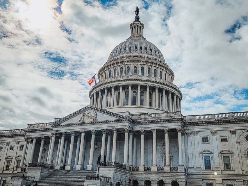 The U.S. Capitol stands against the a partly cloudy sky. The Capitol, and other buildings are something you should do when visiting Washington, DC.