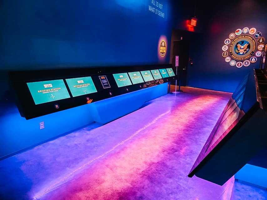 A bank of screens available for interaction with guests await at the Spy Museum in Washington, DC.