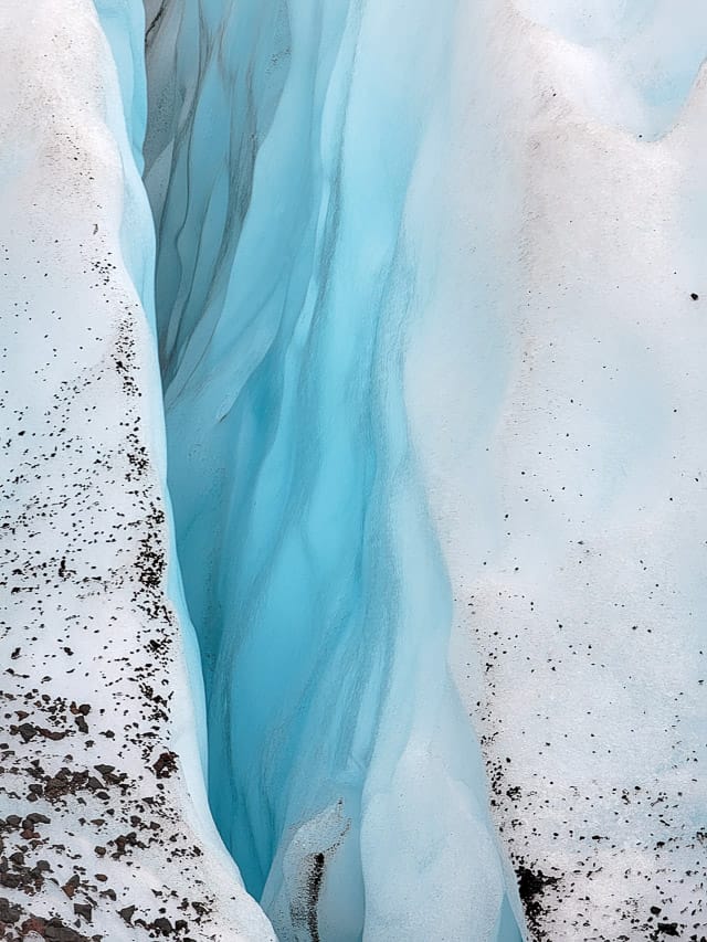 A light deep blue ice crevasse inside the glacier.