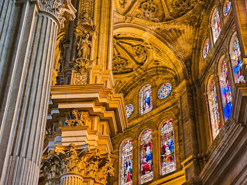 A close up of the intricate columns, ceiling, and stained glass of the cathedral.