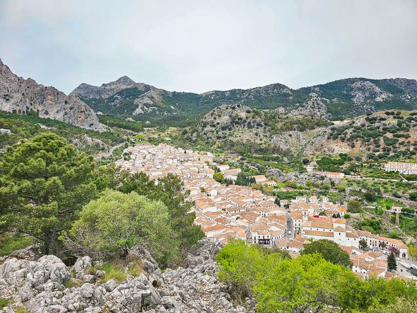 Another viewpoint of Grazalema from very high up, looking down on the white houses, and a lot of rocks and trees around the village.