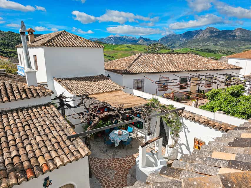 Views over a courtyard bnb and to the green hills and mountains in the distance.