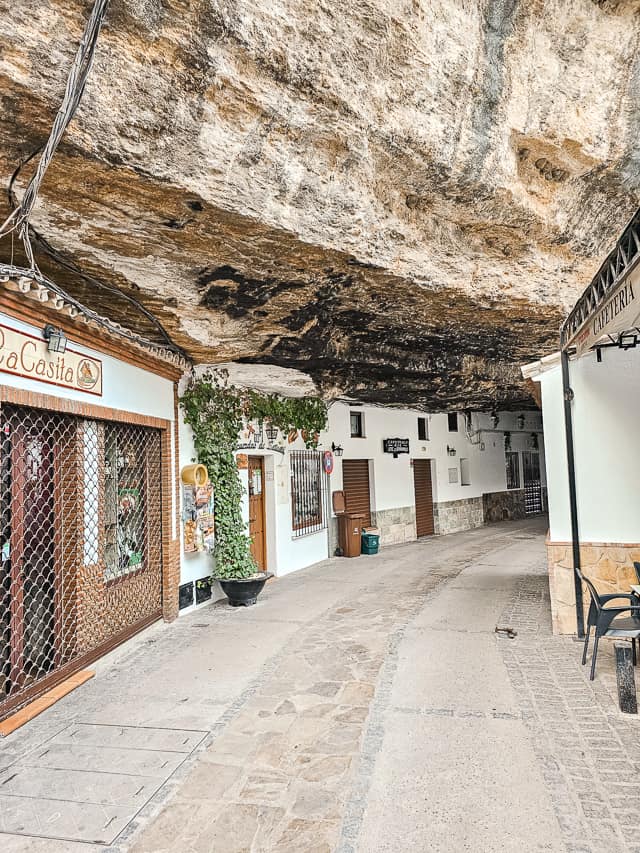 A massive rock covers a street.