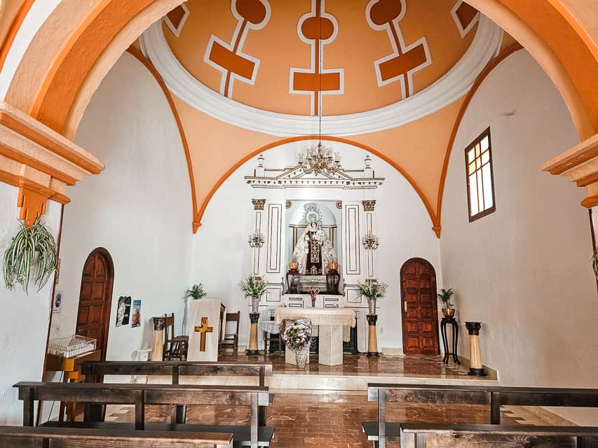 An orange and white domed chapel inside Ermita de Nuestra Senora del Carmen.