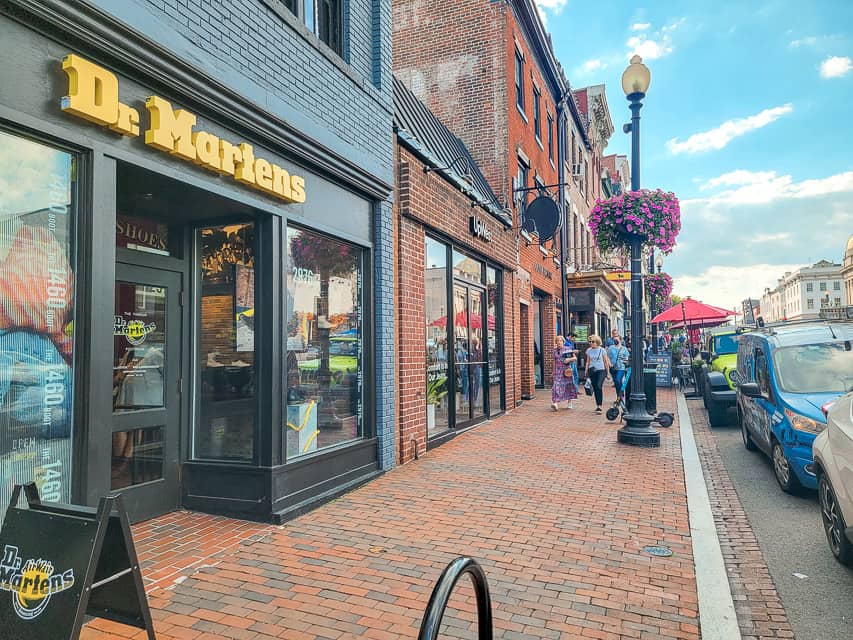 Storefronts line a brick sidewalk in Georgetown.
