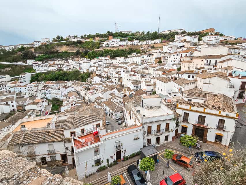 The city of Setenil stretches down a hillside in whites and browns. The view from Mirador del Lizon.