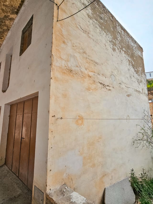 An old tan building with fading paint.
