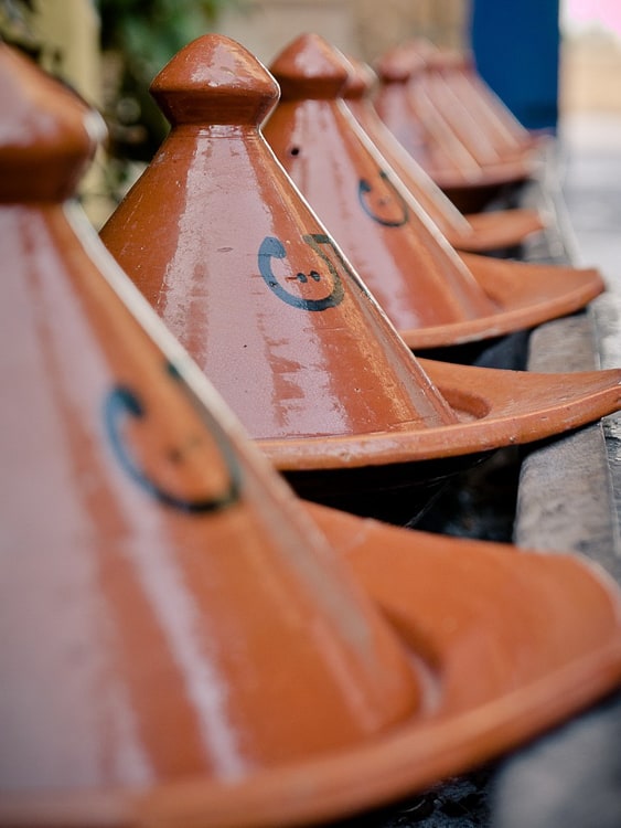 A row of brown, glazed tagine dishes in Morocco.