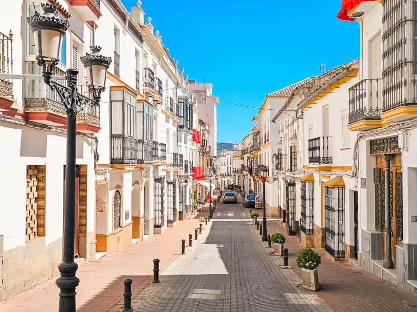 Road with white buildings along the side.