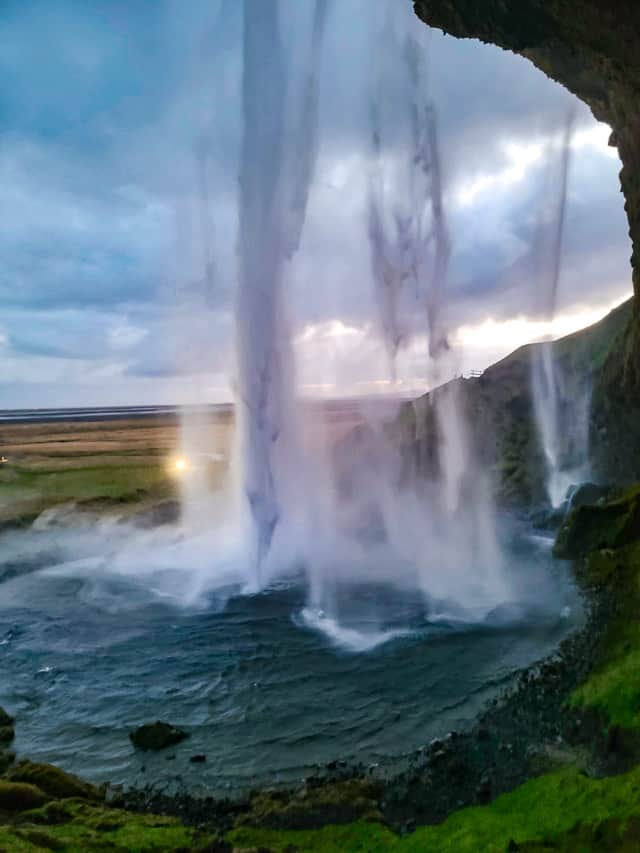 Waterfall falls into a turquoise pool.