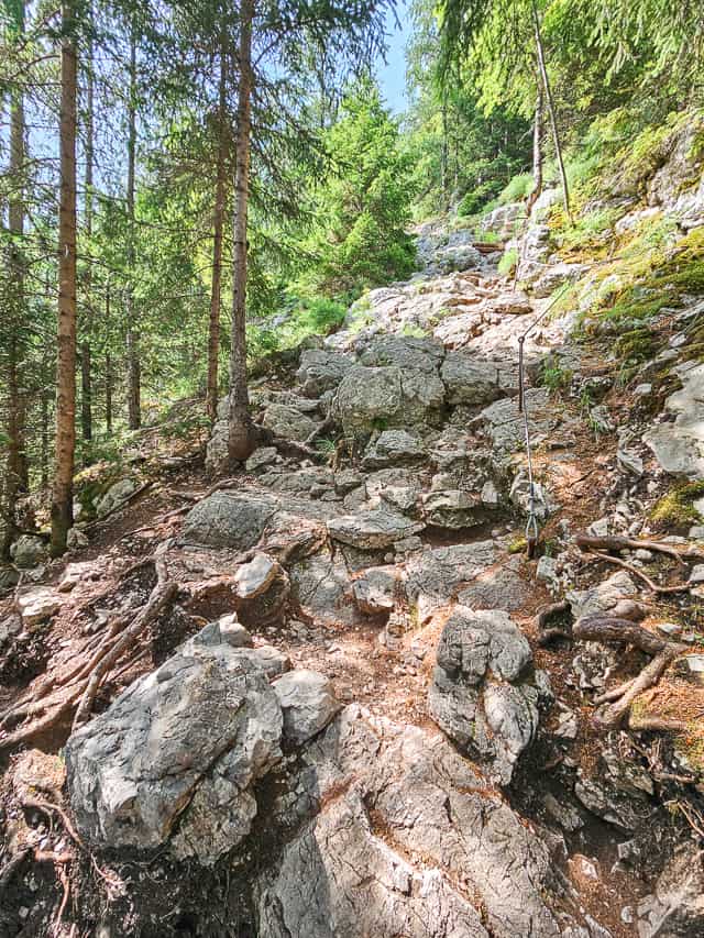A rocky trail goes up the mountain side.