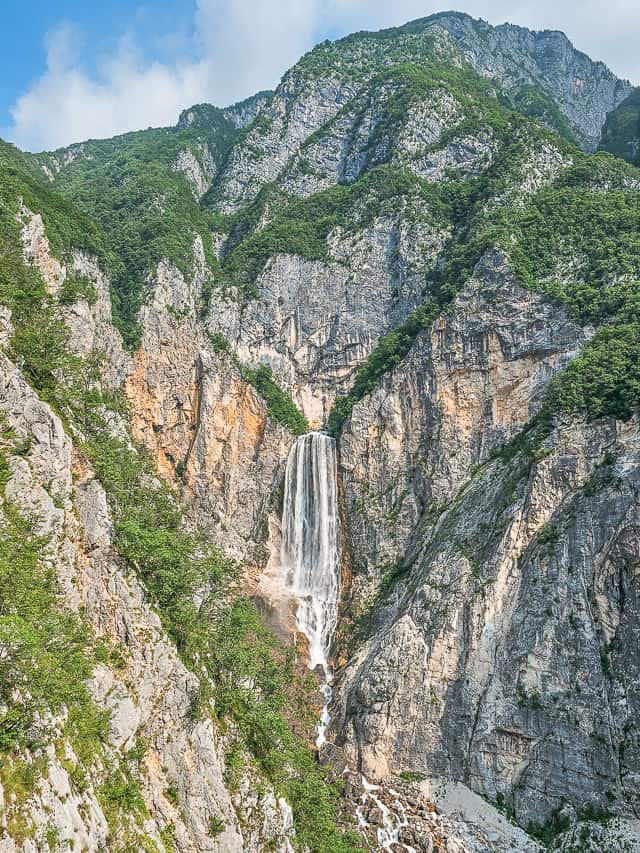 On a faraway cliff the GIANT Boka waterfall goes down a cliff face.