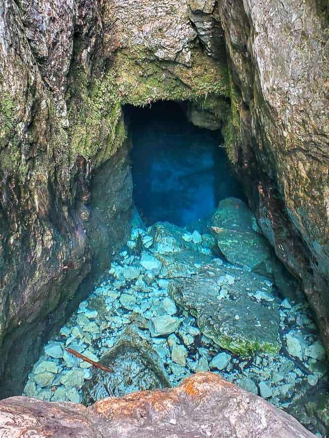 Stunning blue pool inside of the mountain side.