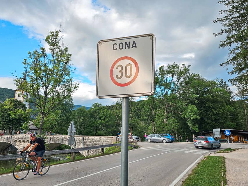 A while sign with a red circle around black letters indicates a speed limit sign - you'll see these frequently when renting a car and driving in Slovenia.