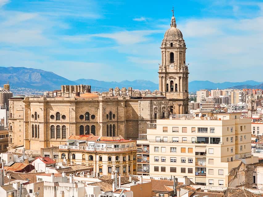 A beautiful spanish skyline with intricate stone buildings and arches.