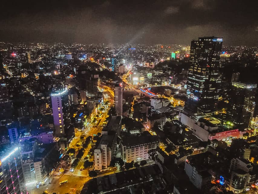 The lit up skyline with skyscrapers/buildings and streets light up brightly.
