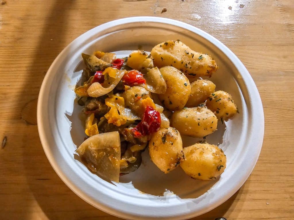 A plate of meat and roasted potatoes.