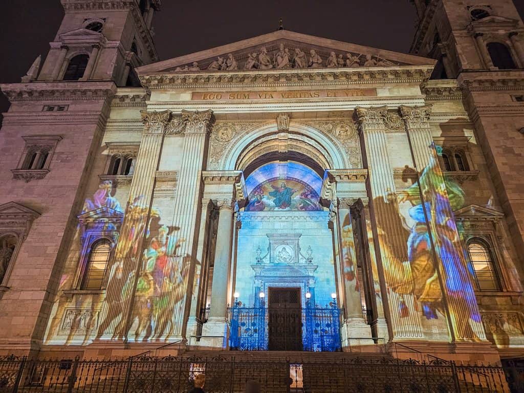 A church with a very intricate projection of the nativity projected onto the outside of the church.
