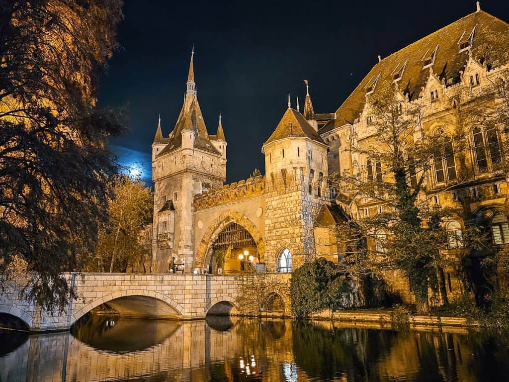 The Vajdahunyad Castle in Budapest sits in front of a river and the ice skating rink.