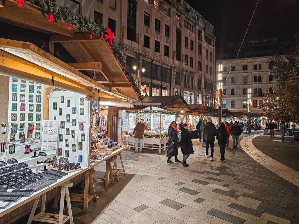 A line of wooden stalls with garlands selling different souvenirs